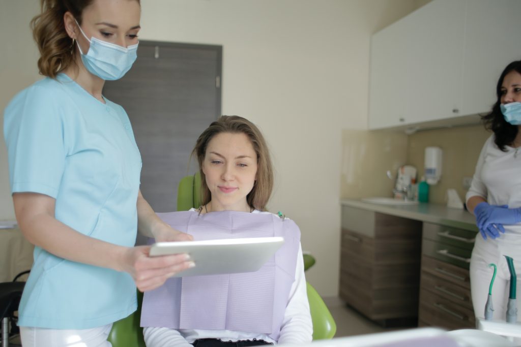 dentist showing woman her dental chart